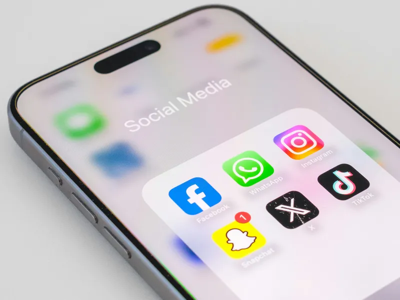 Smartphone screen showing a folder labeled ‘Social Media’ with popular app icons: Facebook, WhatsApp, Instagram, TikTok, X (formerly Twitter), and Snapchat