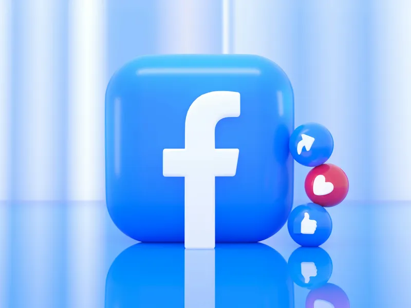 3D Facebook logo icon with social media reaction buttons including like, love, and share, displayed on a glossy blue background.